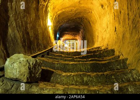 Mysterious dungeon- tunnel with walls made of stone Stock Photo