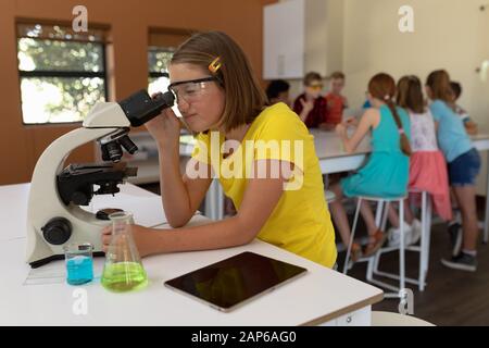 Elementary school girl in chemistry class Stock Photo