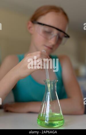 Elementary school girl in chemistry class Stock Photo
