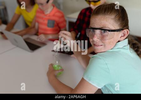 Elementary school girl in chemistry class Stock Photo