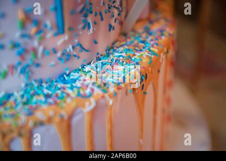 Close up photo of homemade russian easter cakes decorated with white glaze and small colored sugar balls . blue cake with colorfull small sweet ball Stock Photo