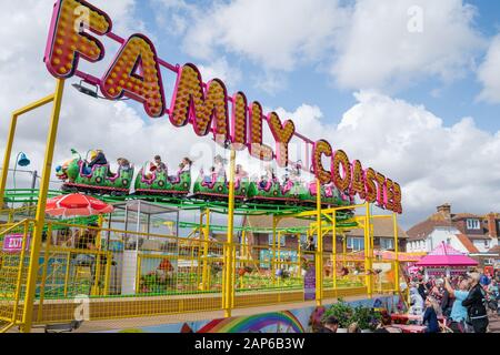 Dymchurch England - August 19 2019; Amusement Park Family Coaster ride with people riding and watching.11 Stock Photo