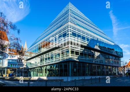 Ulm, Germany, December 29, 2019, Beautiful modern architecture building of the public library in downtown, a glass pyramid serving over 480k print med Stock Photo