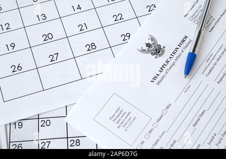Thailand Visa application form and blue pen on paper calendar page close up Stock Photo