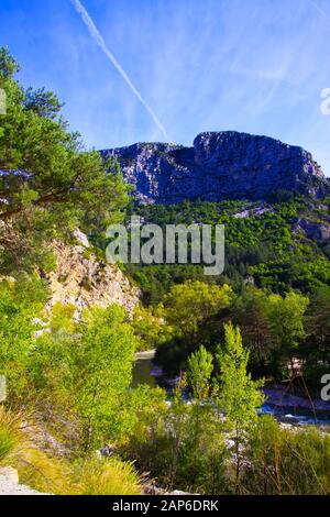 View over green valley on mountain peak against blue sky - Gorges du Verdon, Provence, France Stock Photo