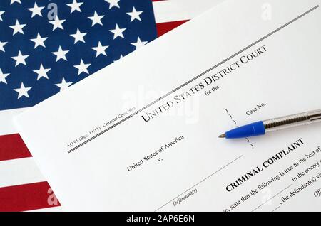 District Court Criminal complaint court papers and blue pen on United States flag close up Stock Photo