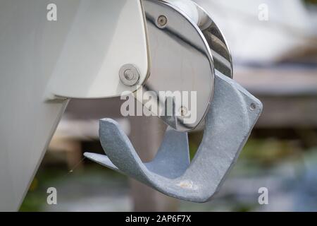 Sailboat with metal anchor hanging Stock Photo