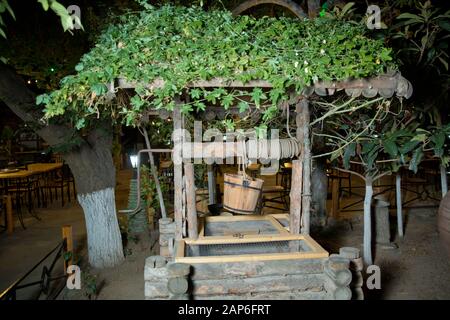 An old well and a bucket of water .old wooden well water .Old stones and wooden wells .well and bucket cutout for making composite photo . Stonegate Stock Photo