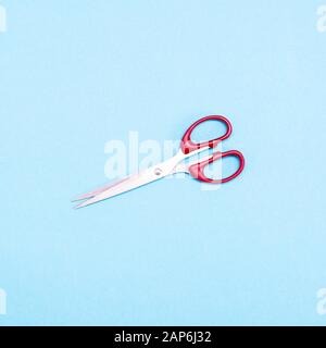 scissors on a blue background, top view Stock Photo