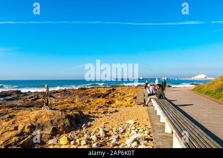 Porto Homem do Leme Beach Picturesque View with Relaxing and Sitting People on a Sunny Blue Sky Day Stock Photo