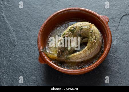 Cooked whitings that have been roasted in the oven with butter and dressed with fresh parsley and a squirt of lemon juice. The style they have been co Stock Photo