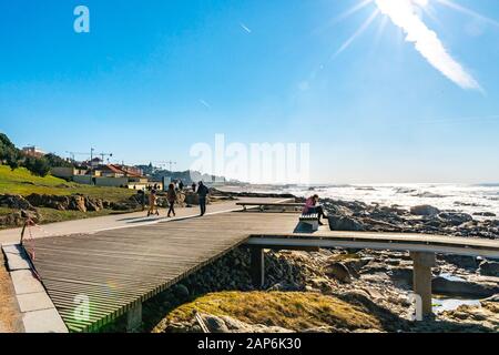 Porto Homem do Leme Beach Picturesque View with Walking and Sitting People on a Sunny Blue Sky Day Stock Photo