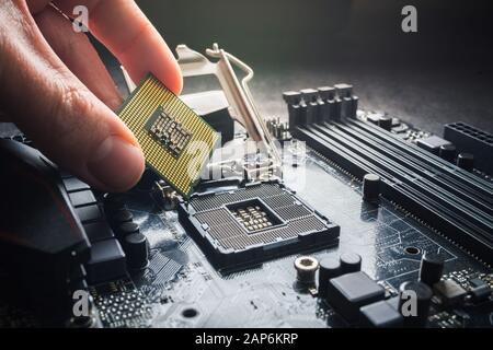 Electronic engineer of computer technology. Maintenance computer cpu hardware upgrade of motherboard component. Pc repair, technician and industry Stock Photo