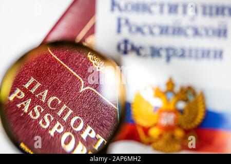 Russian passport under a magnifying glass with the Constitution of the Russian Federation on white background Stock Photo