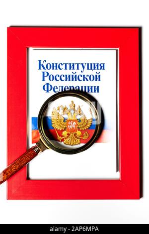 Brochure "Constitution of the Russian Federation" under a magnifying glass in a red frame on a white background Stock Photo