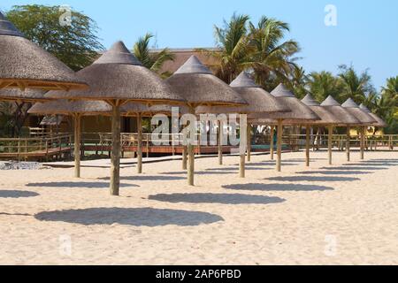 Wooden Beach Umbrellas on sandy beach Stock Photo