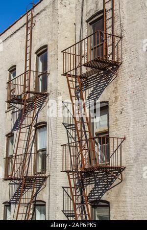 New York Building Fire Escape with white brick wall Stock Photo