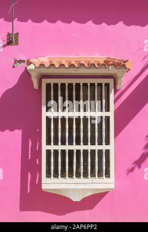 Spanish style window on pink wall Stock Photo