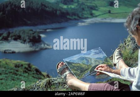 Artist doing an oil painting of Haweswater in the Lake District National Park, Cumbria, UK. Stock Photo