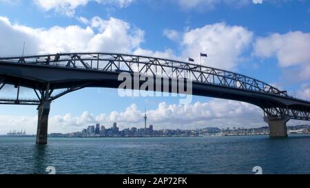 Looking over Waitemata Harbour at downtown Auckland city from the North Shore with the Harbour Bridge in foreground. New Zealand. Stock Photo