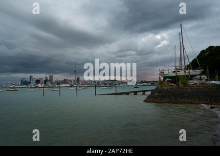 Looking over the Waitemata Harbour towards Auckland city from the North Shore early evening. New Zealand. Stock Photo