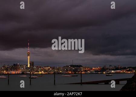 Looking over the Waitemata Harbour towards Auckland city from the North Shore at night. New Zealand. Stock Photo