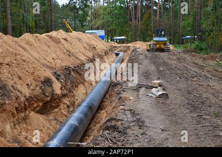 Natural gas pipeline construction work. A dug trench in the ground for the installation and installation of industrial gas and oil pipes. Underground Stock Photo