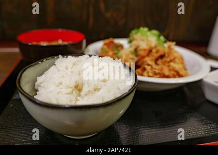 Selected focus view at rice bowl of Japanese style Deep fried Chicken menu, Tori Kara or Tori Pon, serve with miso soup and rice on side. Stock Photo