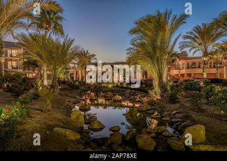 twilight reflections in a stream of water in the garden of Movenpic hotel at el Gouna, Egypt, January 8, 2020 Stock Photo