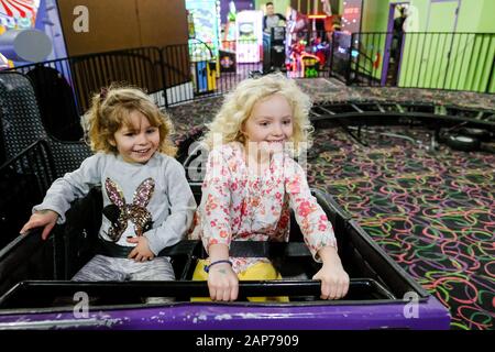 two girls on rollercoaster looking with anticipation and happiness Stock Photo