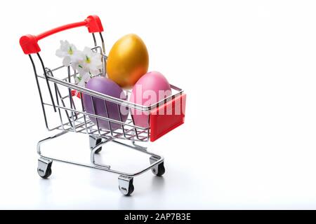 Colorful easter  eggs in shopping cart isolated on white background. Easter concept. Close up. Stock Photo