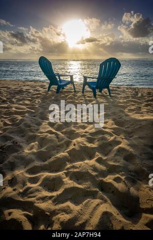 Beach Chairs on beach with palm trees Stock Photo