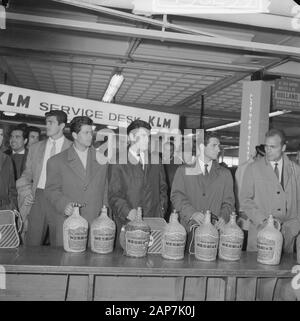 Benfica at Schiphol with about 80 liters of wine Annotation: For final against Real Madrid to play at the Olympic Stadium in Amsterdam. On the labels of the basket bottles vinho de mesa Messias Date: 29 april 1962 Location: Noord-Holland, Schiphol Keywords: airports, football players, wine Stock Photo