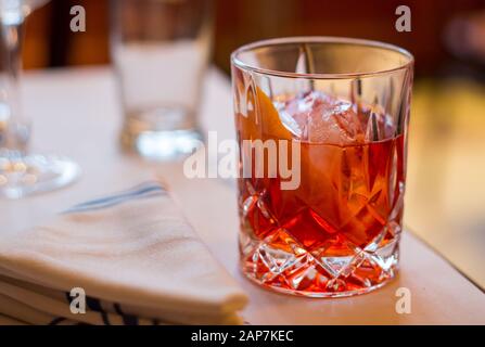 A fresh Negroni poured over ice with an orange twist Stock Photo