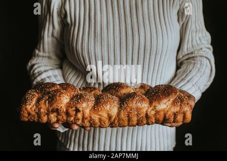 A Woman Holds Homemade Braided Bread Stock Photo