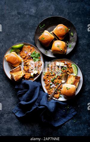 Indian Street Food - Spiced Mashed Vegetable Stew with buttered diner rolls. Stock Photo