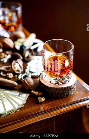 Alcohol and Cigar with nuts, vintage playing cards. Stock Photo
