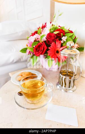 Herbal tea and electronic room key in the upscale hotel room. Being alone, getaway, staycation, digital detox concepts. Vertical Stock Photo