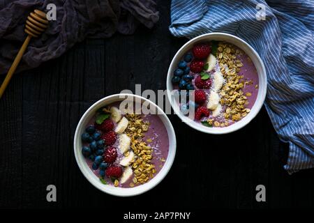 Two acai berry smoothie bowls shot from overhead. Stock Photo