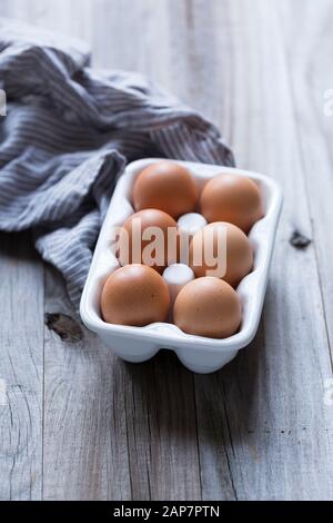 Six eggs in a ceramic egg dish with a napkin. Stock Photo