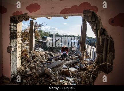 Gaza City, Palestine. 19th Jan, 2020. Toto Hammouda Abu Amra, 15, writes her homework from the ruins of her family's destroyed home.The Abu Umrah family that consists of 19 individuals lost their five-storied house after an Israeli raid on Gaza on November 13, 2019. Credit: SOPA Images Limited/Alamy Live News Stock Photo