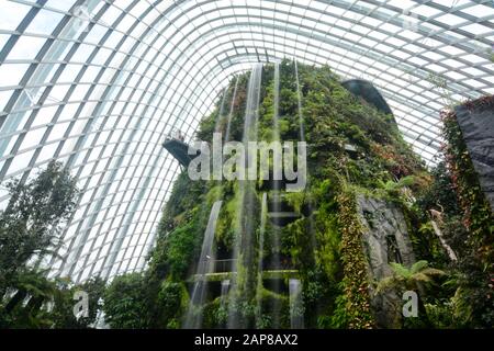 Singapore - September 8, 2018: Huge artificial waterfall in the Cloud Forest at Gardens by the Bay Stock Photo