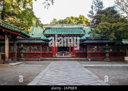 Person Praying at Nezu Shrine, Tokyo Stock Photo