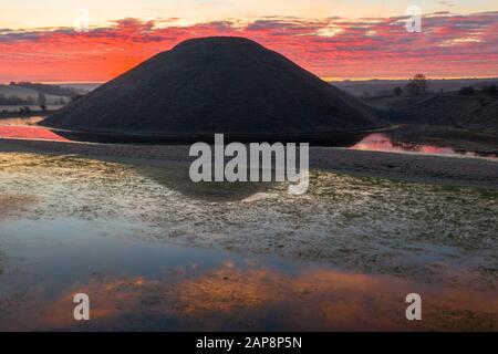 Silbury Hill, Nr Avebury, Wiltshire, UK. 20th January 2020. Drone images of a spectacular red frosty sunrise and the ancient man-made mound of Silbury Stock Photo