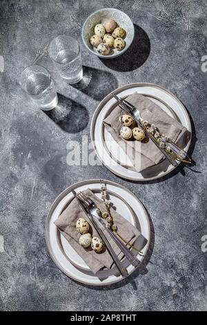 Easter festive table setting with quail eggs. top view Stock Photo