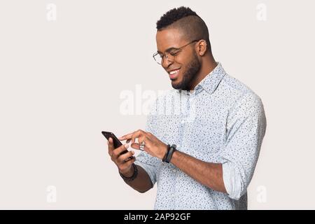 Happy black man using smartphone get pleasant message Stock Photo