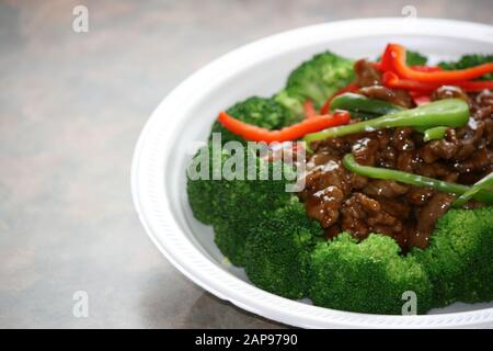 Asian or Chinese food dishes or stir fries at take out or eat in restaurant Stock Photo