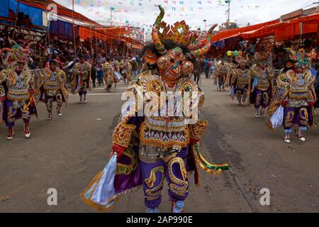 Diablada dancers in ornate costumes parade through the mining city of Oruro on the Altiplano of Bolivia during the annual carnival. Stock Photo