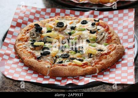 Fresh backed Italian pizza with pepperoni, mushrooms, sausage,  pizza saus mozzarella cheese Stock Photo