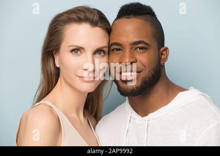 Headshot of happy multiethnic couple posing in studio Stock Photo